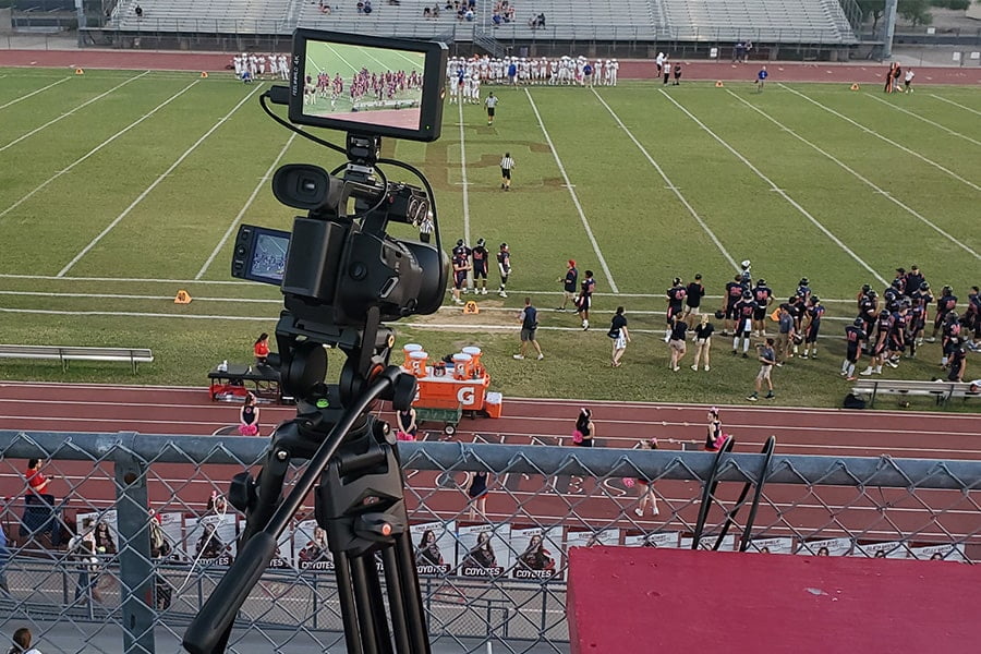 Sports video camera pointed at football field, filming a full game